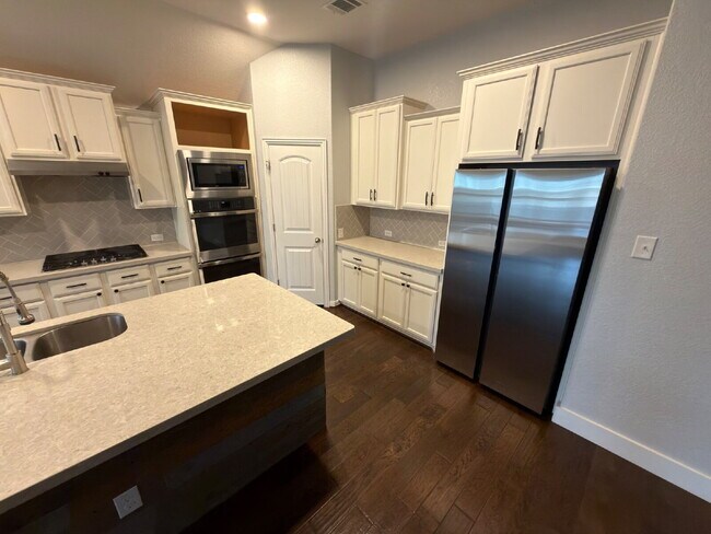 Building Photo - Four bed two bath on a corner lot with a pool in Sunfield. Gas cook top, double ovens. Open kitch...