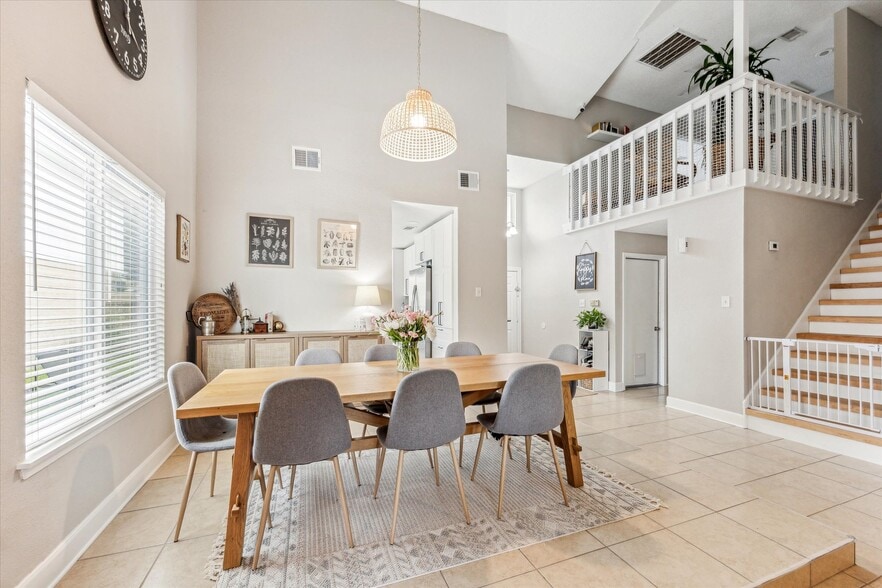 Open floor plan dining and living spaces - toward kitchen and entry - 13511 Windchase Ct