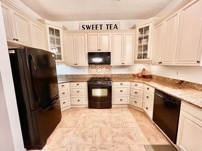 Building Photo - Beautifully renovated 4BR/3BA rambler with wraparound porch and garage