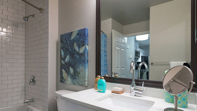 Framed vanities, floor to ceiling tile surround, and granite countertops - Alister Quincy