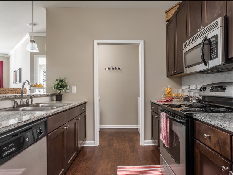 Culinary Inspired Kitchen with Tile Backsplash and Granite Countertops - Talison Row at Daniel Island Apartments