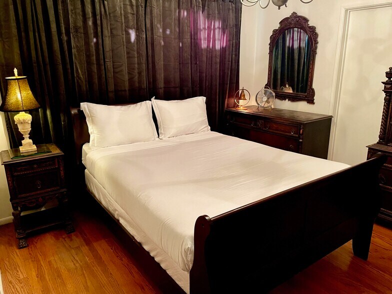 Vintage antique bedroom furniture accents the master bedroom that has its own bathroom - 11449 Woodbine St