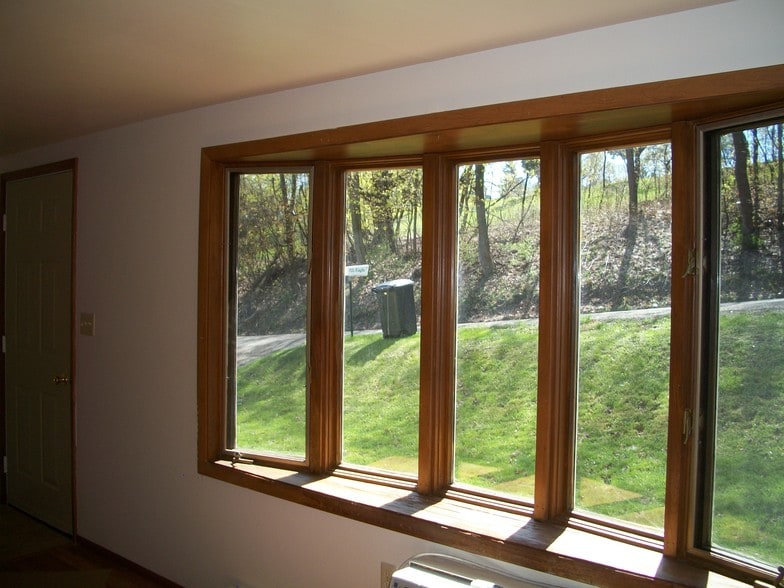 Bay window in living room next to entry door. - 502 Mercer Rd