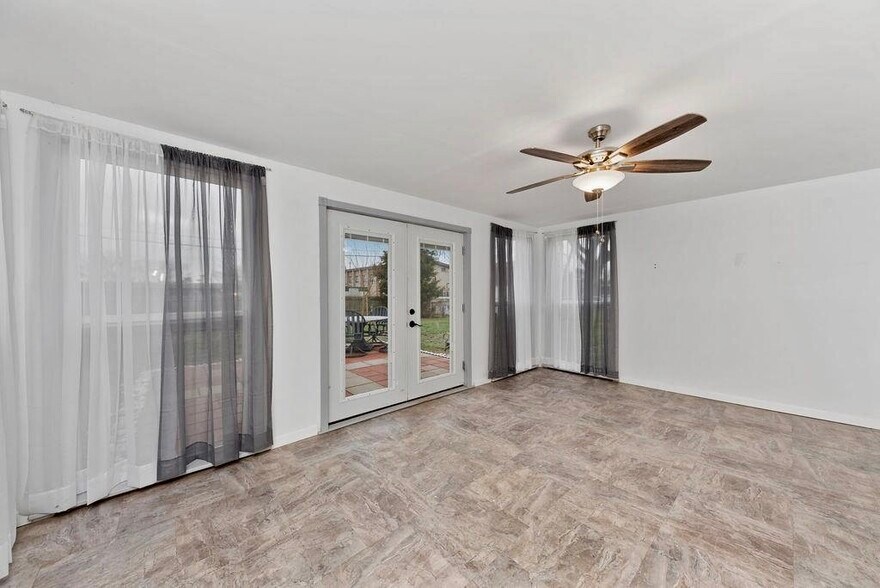 Lovely Sunroom off kitchen - overlooking patio and fully fenced back yard! Ceiling fan and independent mini-split for heating / cooling! - 11 Lawndale Ave