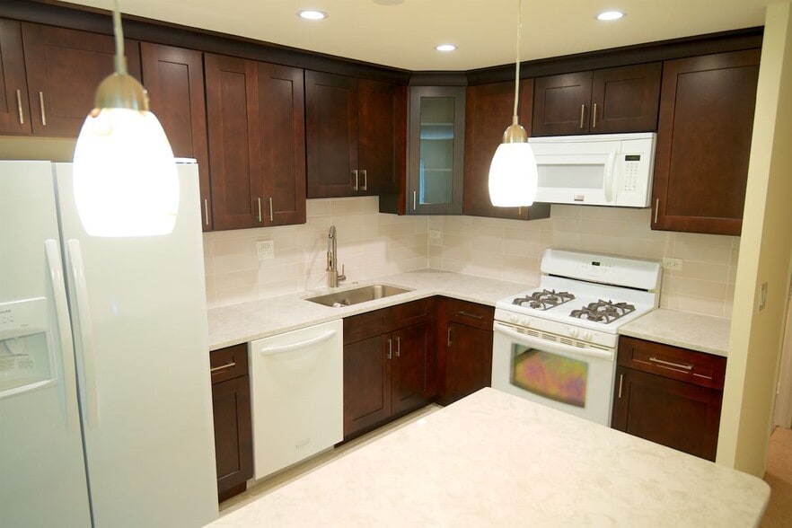 Open Kitchen with isle and pendant lights - 1250 Park Ave W