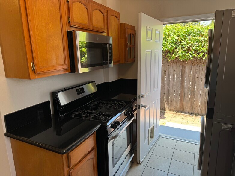 Range and microwave included. Easy access to private yard! - 2920 S Sycamore Ave