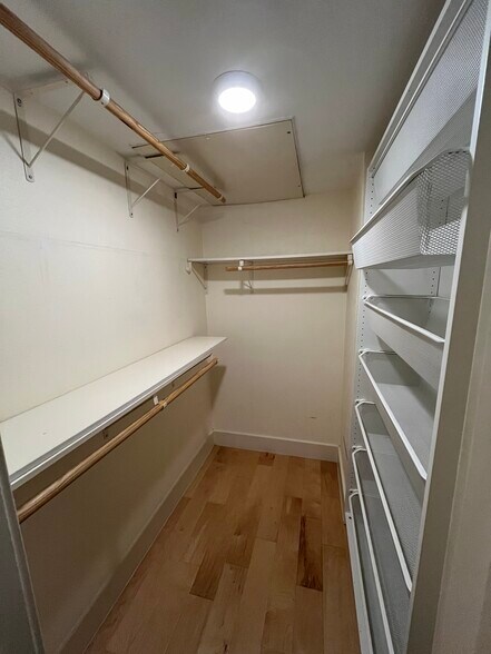 The master closet also features moveable shelves (right) that provide easy access for clothes. - 909 Reinli St
