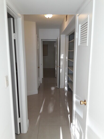 split bedrooms with 3 closets in between - 1670 NE 191st St