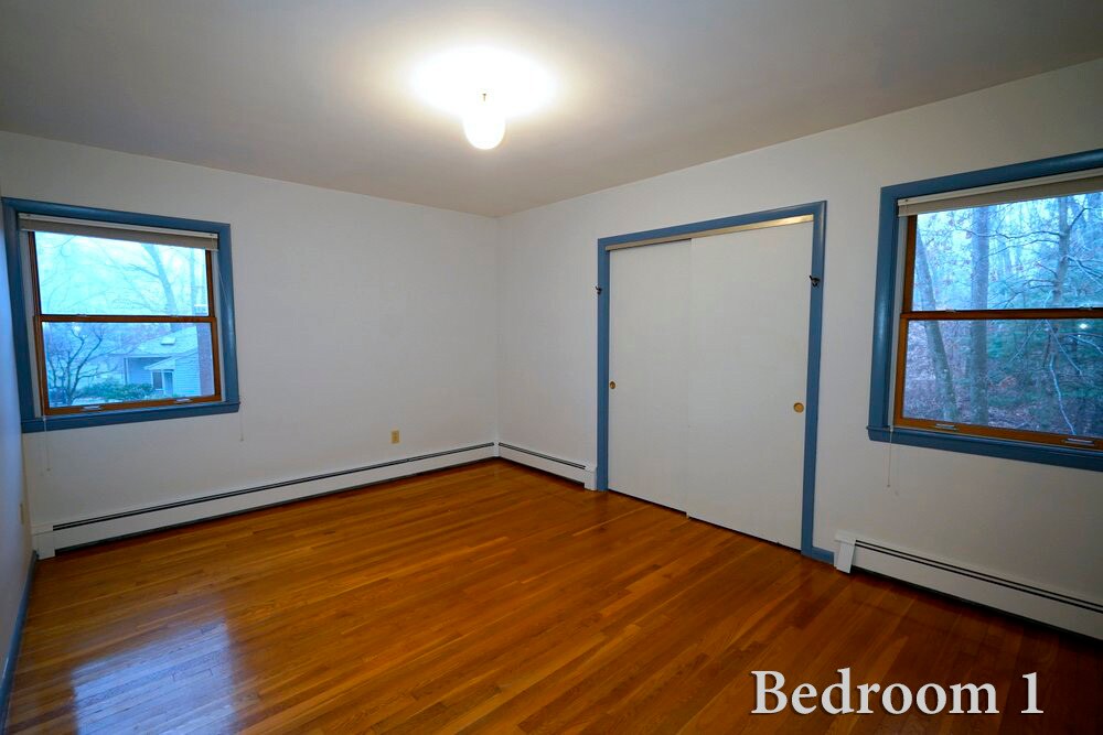 Bedroom 1 with large closet and view of the woods - 208 Grove St