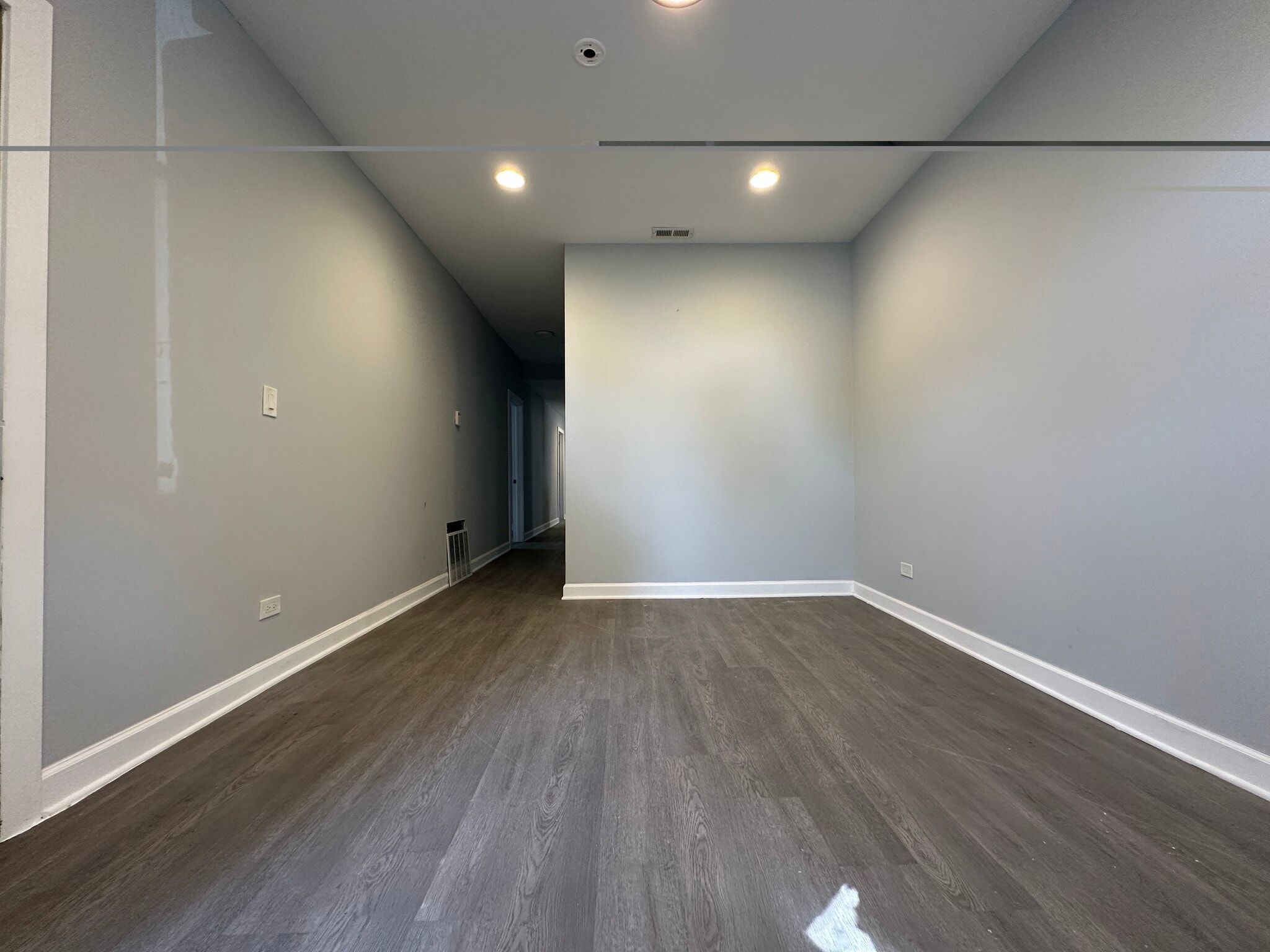 Living room with fresh paint and new flooring throughout - 5653 S May St
