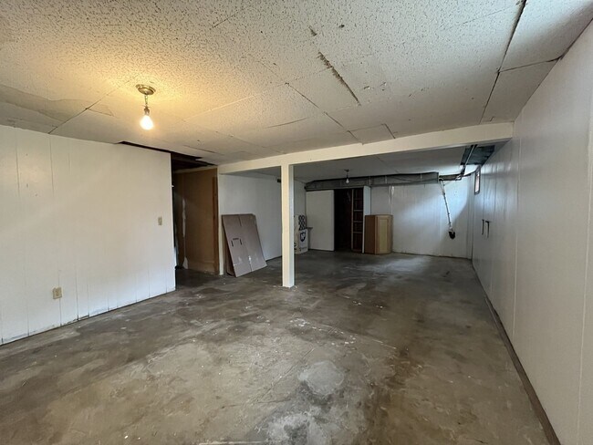 Building Photo - Three-Bedroom Home with Updated Kitchen & Vaulted Ceilings, large open basement, Hardwood floors