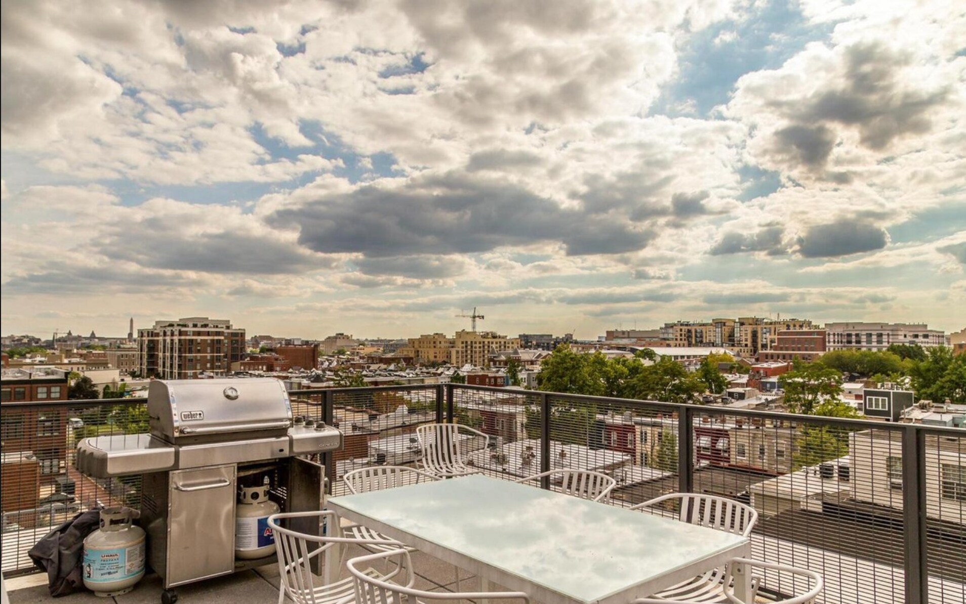 Rooftop patio with community grill and dining table - a shared common space. - 2250 11th St NW