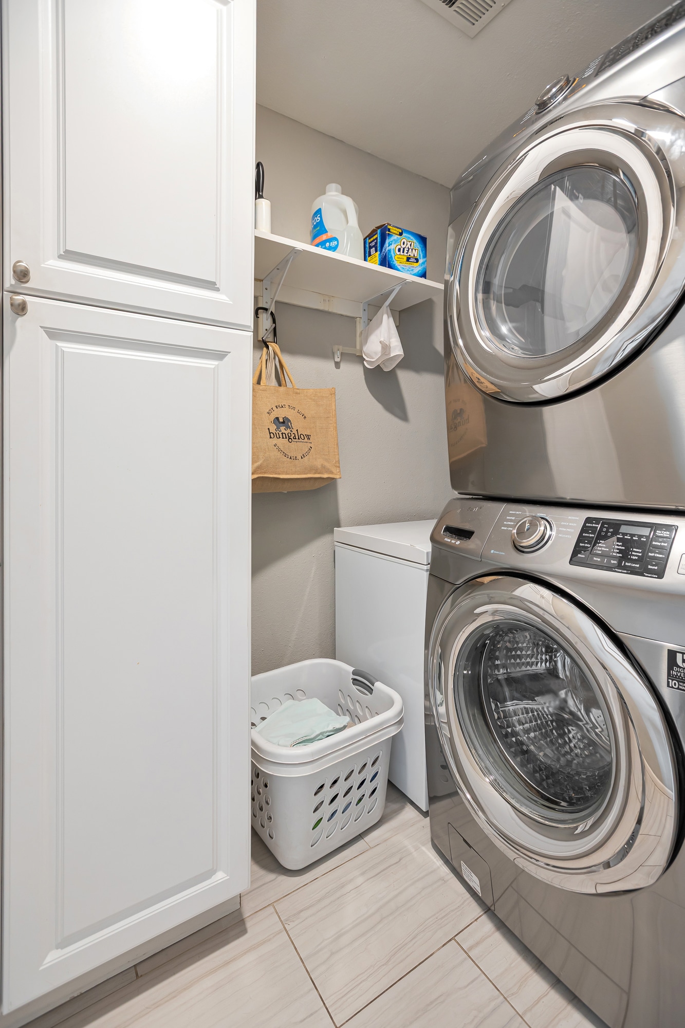 Laundry room with Samsung stacked washer/dryer, pantry storage, and chest freezer - 6136 N 9th St