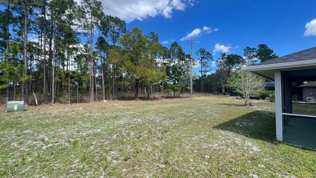 Building Photo - Bright & Spacious 3/2 Home with Huge Yard + Screened Patio — Lawn Care Included!