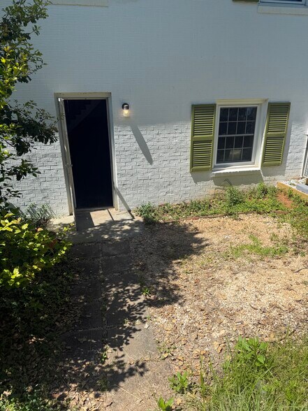 Exterior Rock Pebble Sitting Area (To be cleaned up before moving in!!) - 331 Key West Dr