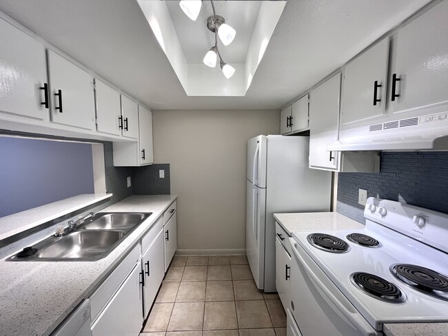 Experience culinary delight in this sleek, modern kitchen designed for efficiency. - Inertio Apartments