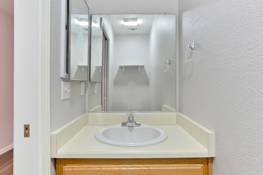 The downstairs bathroom located near the front entrance of the home. - 3038 Courtside Dr