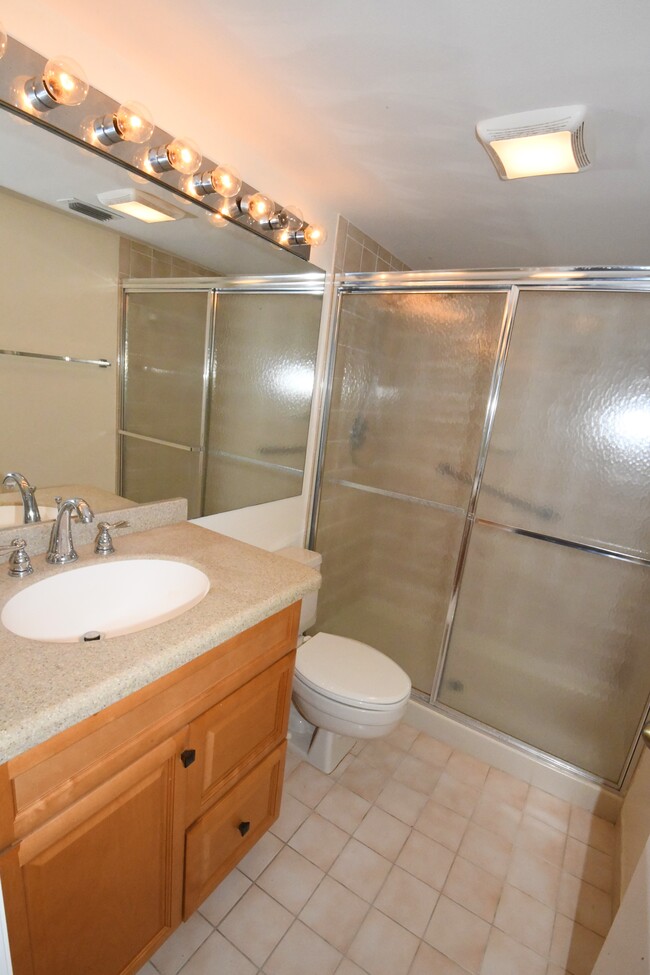 Updated master bathroom with Corian countertop. - 1935 Silver Pine SW Way