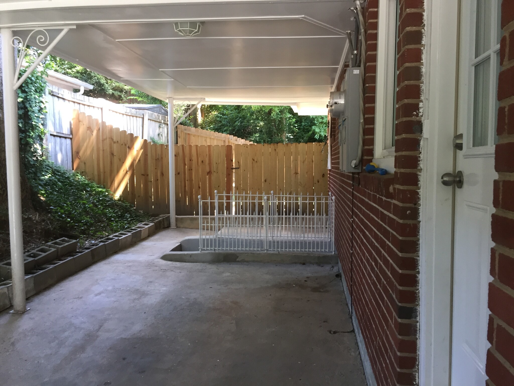 Side entrance viewing the fenced in backyard and the shared basement storage - 430 Wimbledon Road Northeast