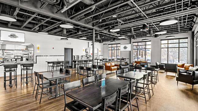 Experience the charm of this stylish community dining space, perfect for gatherings and social events. - The Station Lofts