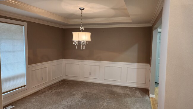 Formal dining room with wainscotting and view of front yard - 7409 245th Way NE