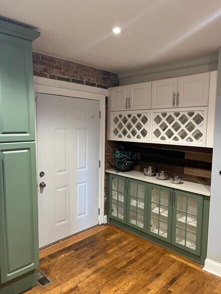Kitchen w/glass front cabinets & wine rack - 223 Jackson St
