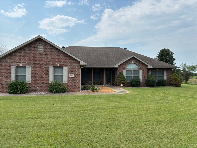 Front of house facing Old Highway 63 - 5225 E Dee Woods Rd