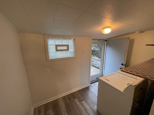 The mudroom leads to a pleasant back patio with a lush green low maintenance yard - 212 Lorenz Ave