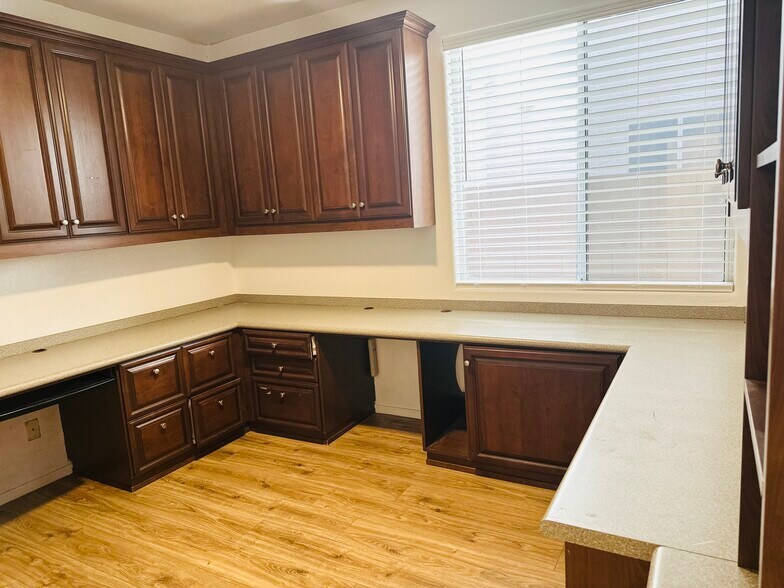 Downstairs office with custom cabinetry and a wraparound workspace. - 1177 W Laredo Ave