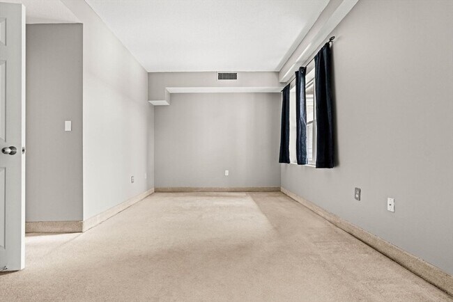 Building Photo - Updated 1BR Condo with Balcony, Garage Parking & Storage Near Commuter Rail