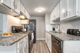 This gorgeous renovated kitchen boasts modern appliances, updated countertops, and elegant finishes, creating the perfect space for cooking and entertaining. - Villa De Oro