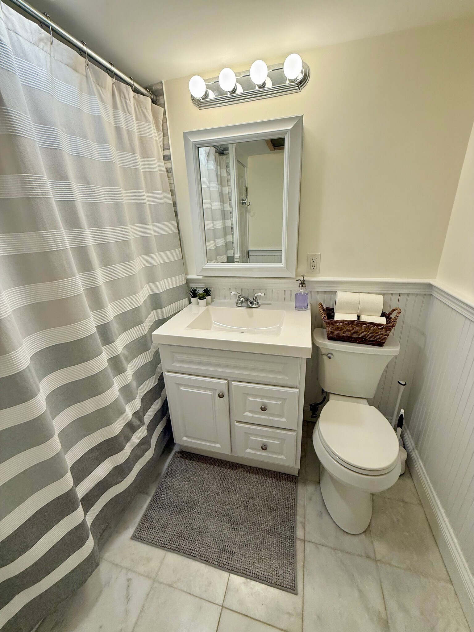 bathroom - front view; plenty of storage behind mirror and under sink - 382 Riverway St