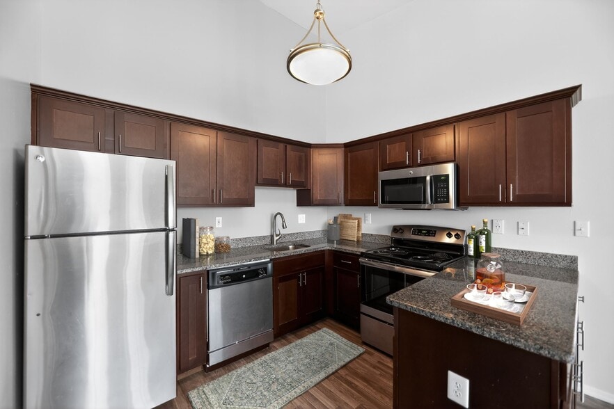 Elevate your lifestyle at Mansions at Delmar, an Eagle Rock Community. This stunning kitchen features modern appliances, sleek countertops, and ample storage. Perfect for culinary enthusiasts. Schedule a tour today to see your new home! - Mansions at Delmar, an Eagle Rock Community