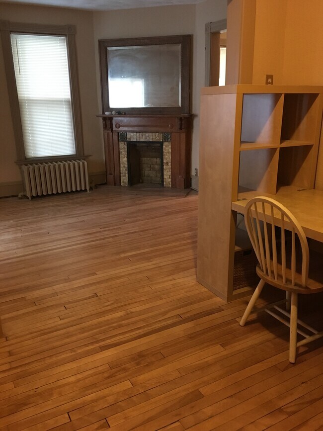 The foyer opens to the living room with decorative fireplace - 3452 Nicollet Ave