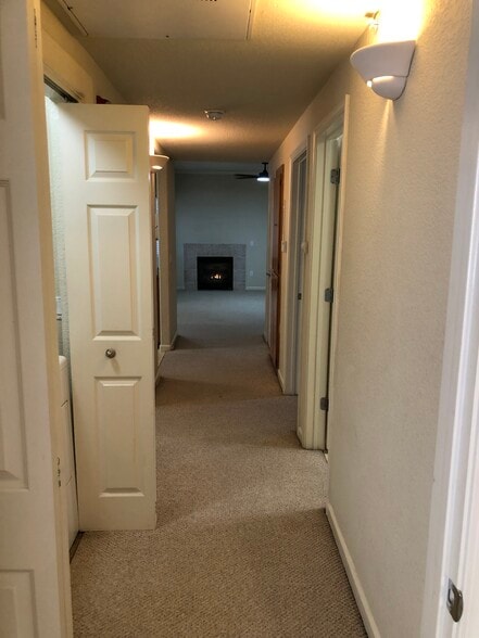 Hallway view from master. Laundry to the right, Bathroom to the left and 2 bedrooms. - 10001 Woodcreek Oaks Blvd
