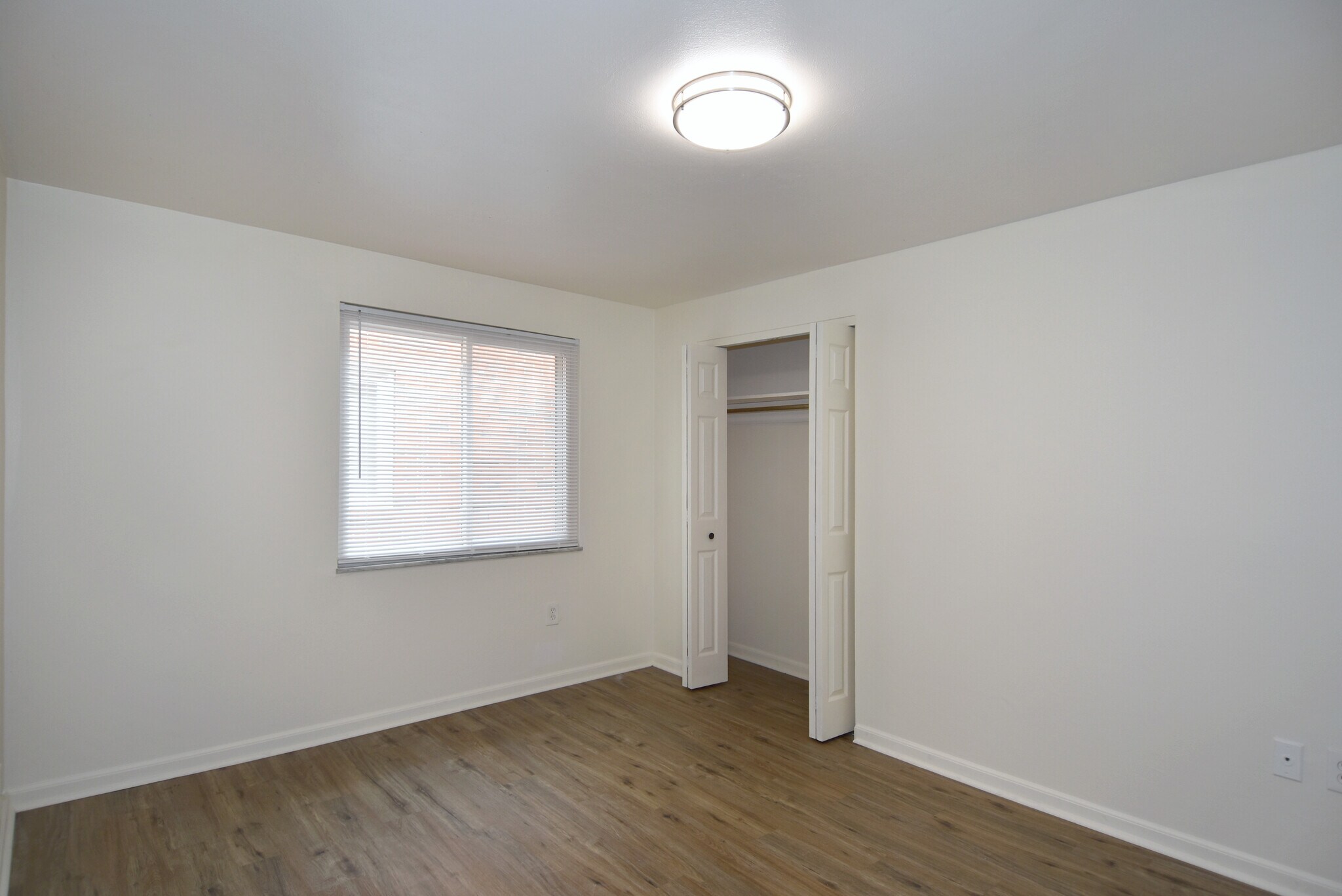 Freshly painted spacious bedroom #1 with all-new luxury vinyl plank flooring, new mini-blinds & LED - 3156 Glendale Ave