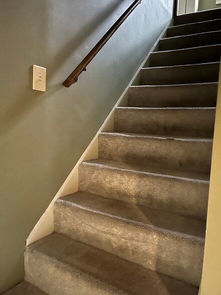 Stairs off the living room lead to two upstairs bedrooms. - 11 Kellogg St