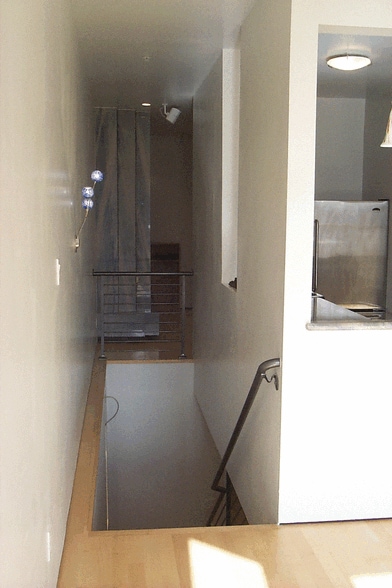 Stairs to 2 bedrooms, 2 bathrooms and laundry downstairs - 12A Reno Pl