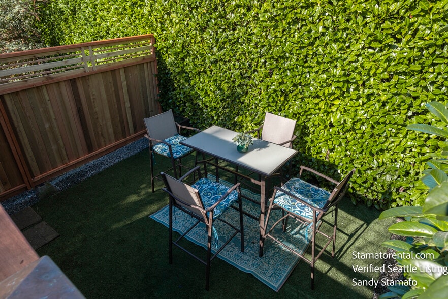 Enjoy outdoor dining in a private garden setting. - 11639 1st Ave NW