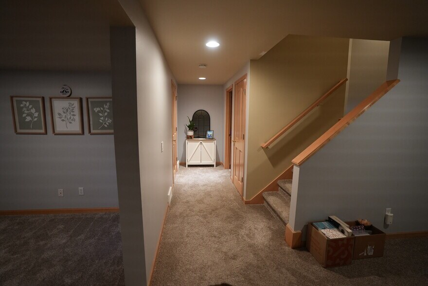 Basement hallway with access to the laundry room and full bathroom - 54 Wood Brook Way