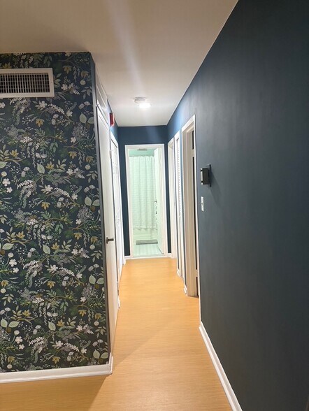 hallway with bathroom, two bedrooms, full closet, and linen closet - 4977 Battery Ln