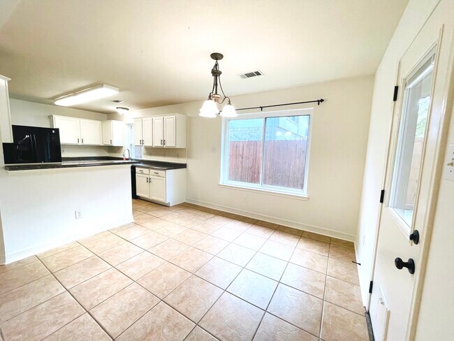 Dining area off the kitchen with a breakfast bar - 14511 Enola Dr