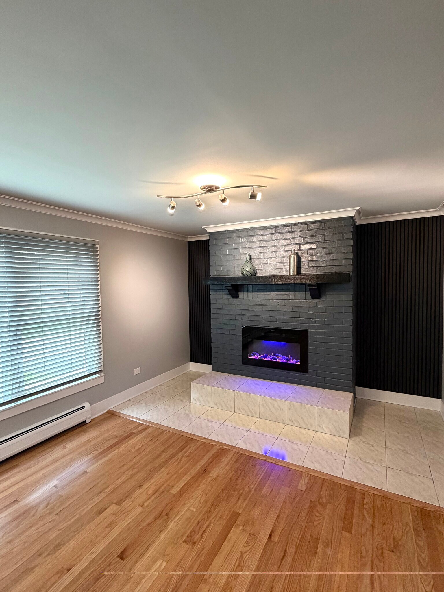 Gorgeous redone fireplace with remote control, sound control decorative back panels. - 771 56th St