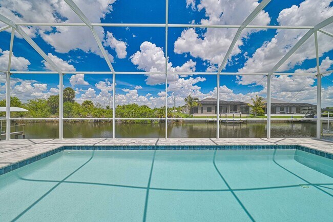 Building Photo - NOW AVAILABLE - Gorgeous Pool Home ~ NW Cape ~ 3 Car Garage ~ On Canal!