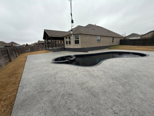 Building Photo - Four bed two bath on a corner lot with a pool in Sunfield. Gas cook top, double ovens. Open kitch...