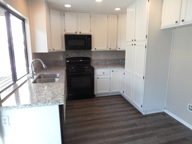 Building Photo - Two Story 4 BR 2.5 BA Condo With 2 Car Garage