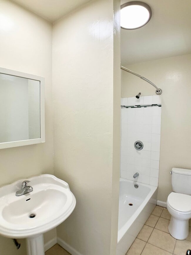Building Photo - TOP FLOOR, Corner Studio. Hardwood Floors!...