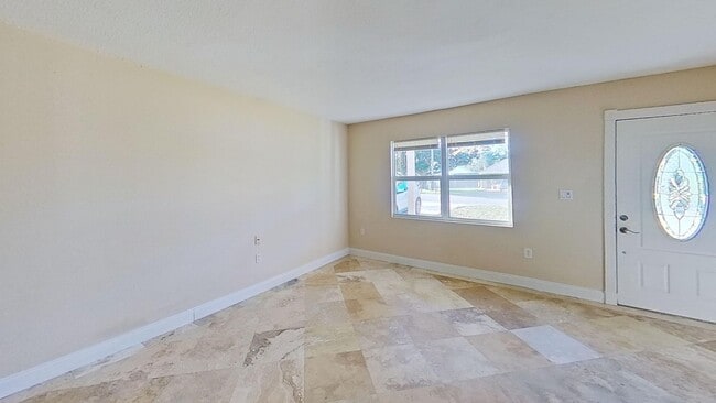 Building Photo - 3/2 with Den and extra long single car garage, huge fenced back yard