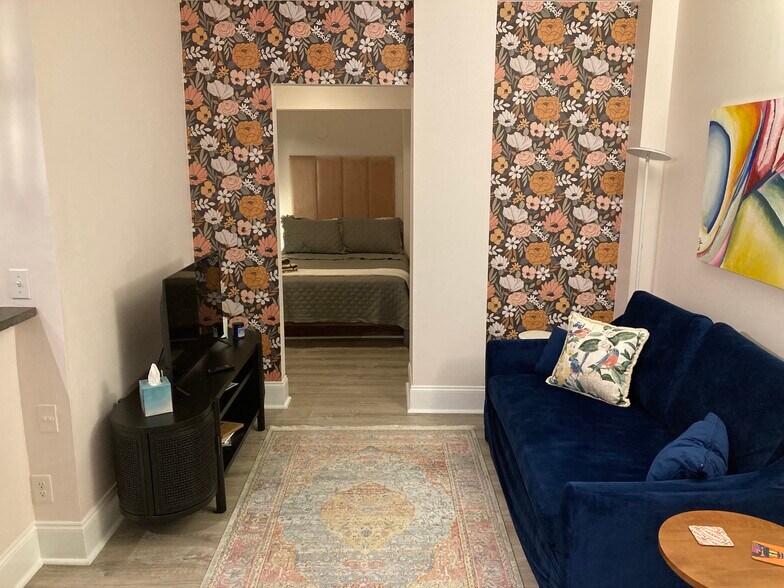 Living area with couch and smart tv - 400 Queens Rd