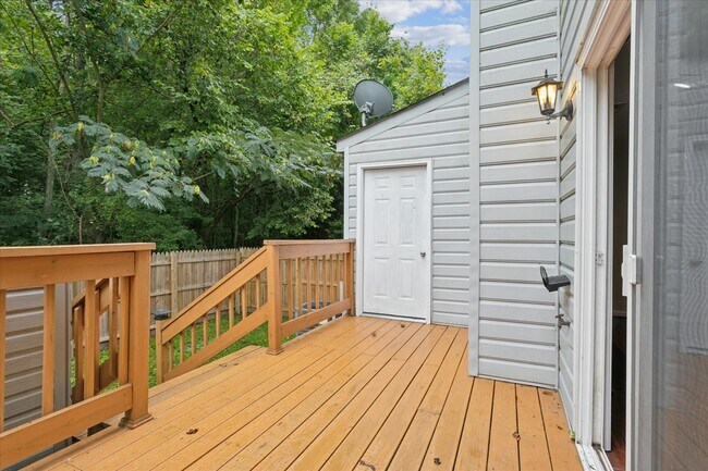 The home offers a large back deck, storage shed, and fully fenced backyard - 1644 Skiffes Creek Cir